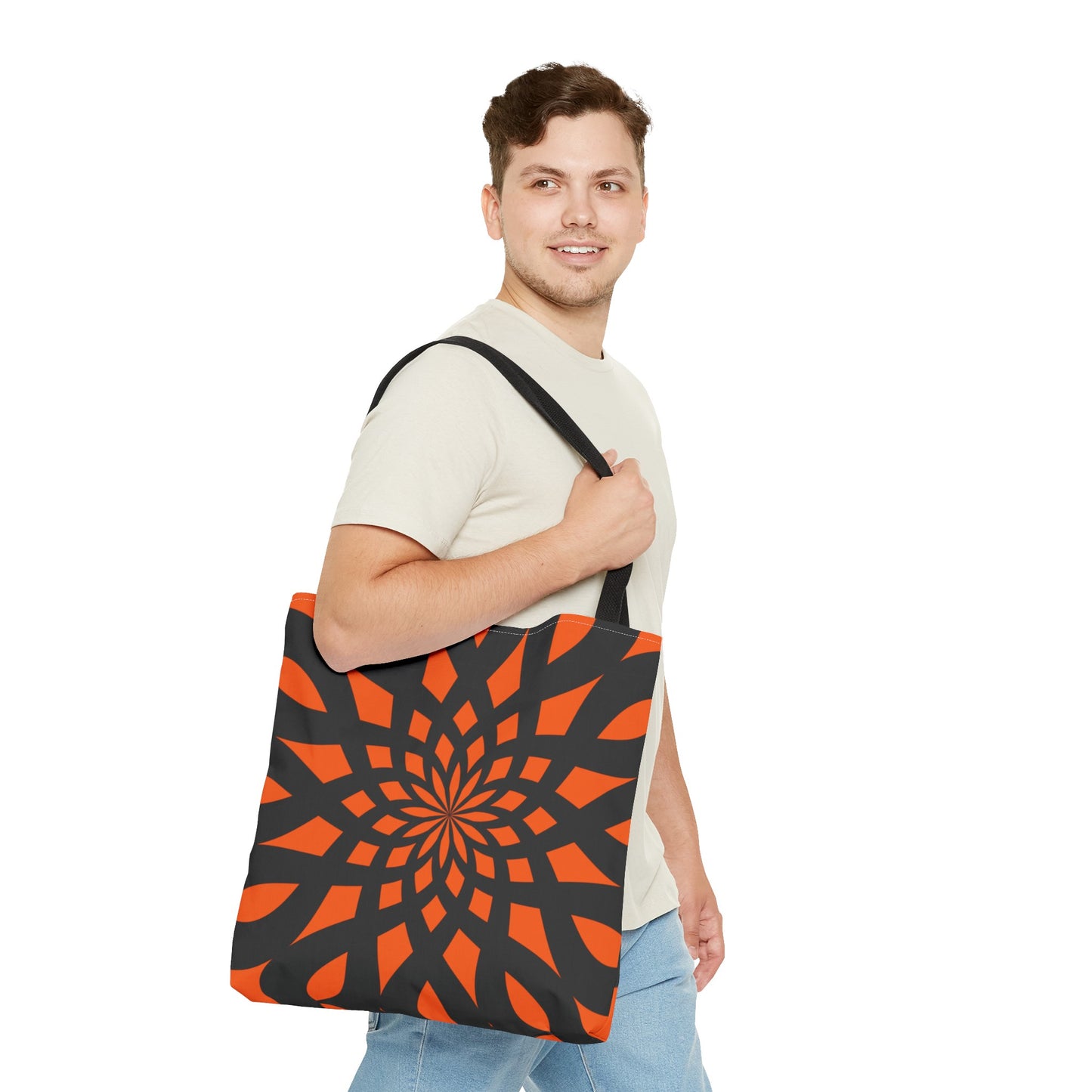 Orange tote bag with the print of mandala like pattern in black. Made with 100% polyester. It is highly durable and perfect for everyday use. A bag is non-woven laminate inside, cotton handles, and are available in 3 sizes, 1x large storage compartment.