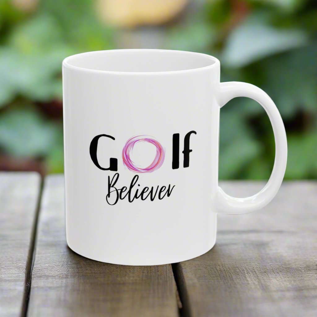 Golf Believer text on the mug. The letter O is in purple-pink.