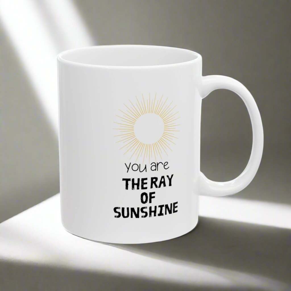 White ceramic mug with the text You are the ray of sunshine and with the image of sun.