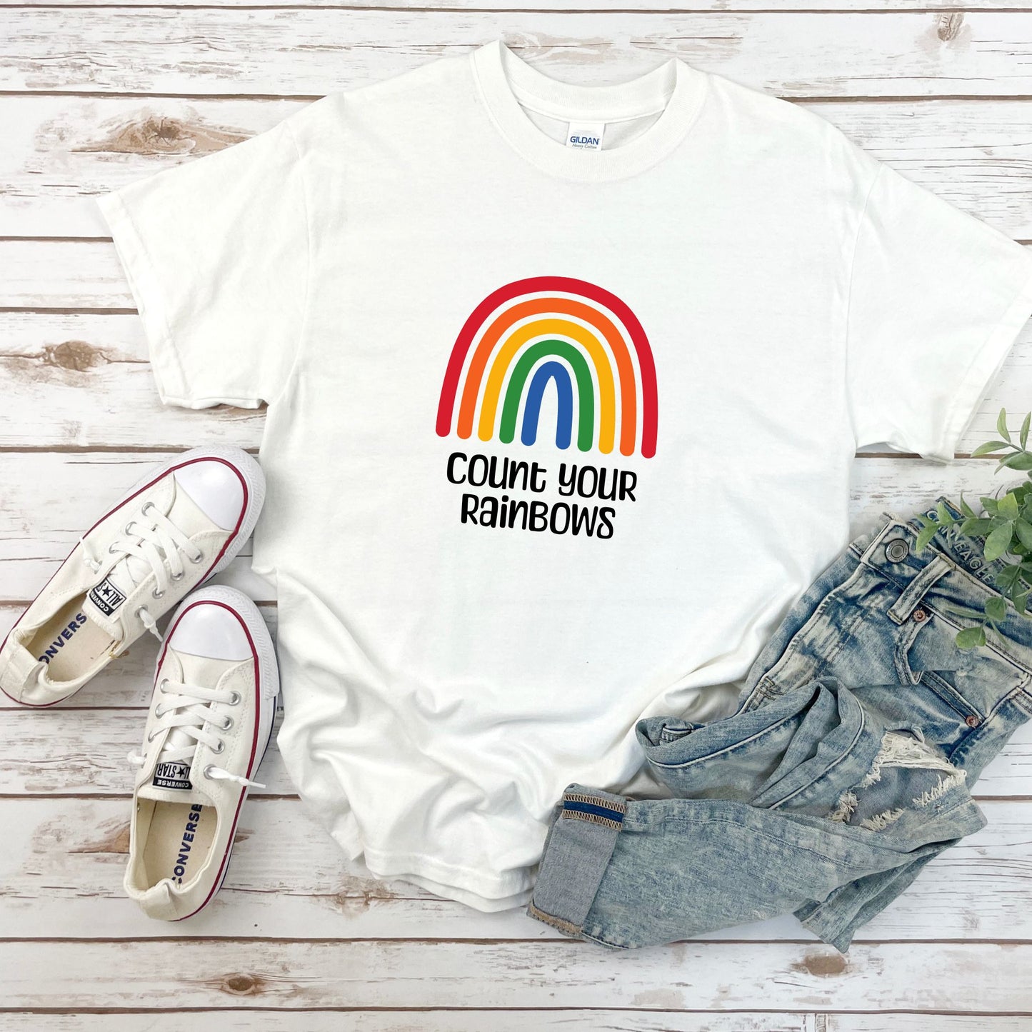 Bright colorful rainbow with the text Count Your Rainbows. White T-shirt.