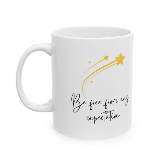 White ceramic mug with the text Be Free From Any Expectation on the both sides of the mug.  Also the image of one bigger and three smaller stars on the mug. Mug size 11 oz.