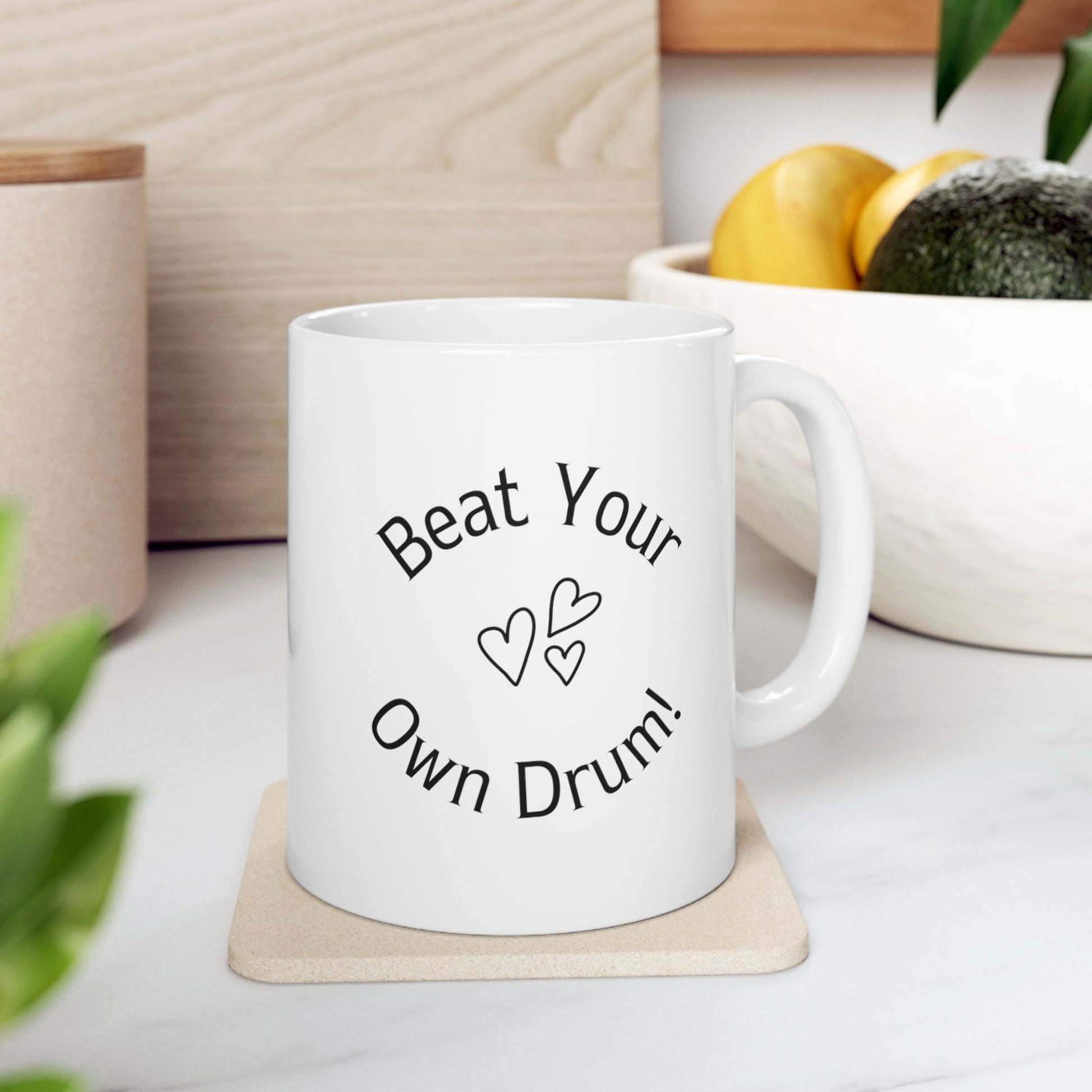 White ceramic mug, 11 oz, with the text Beat Your Own Drum. The best reminder mug for daily use.
