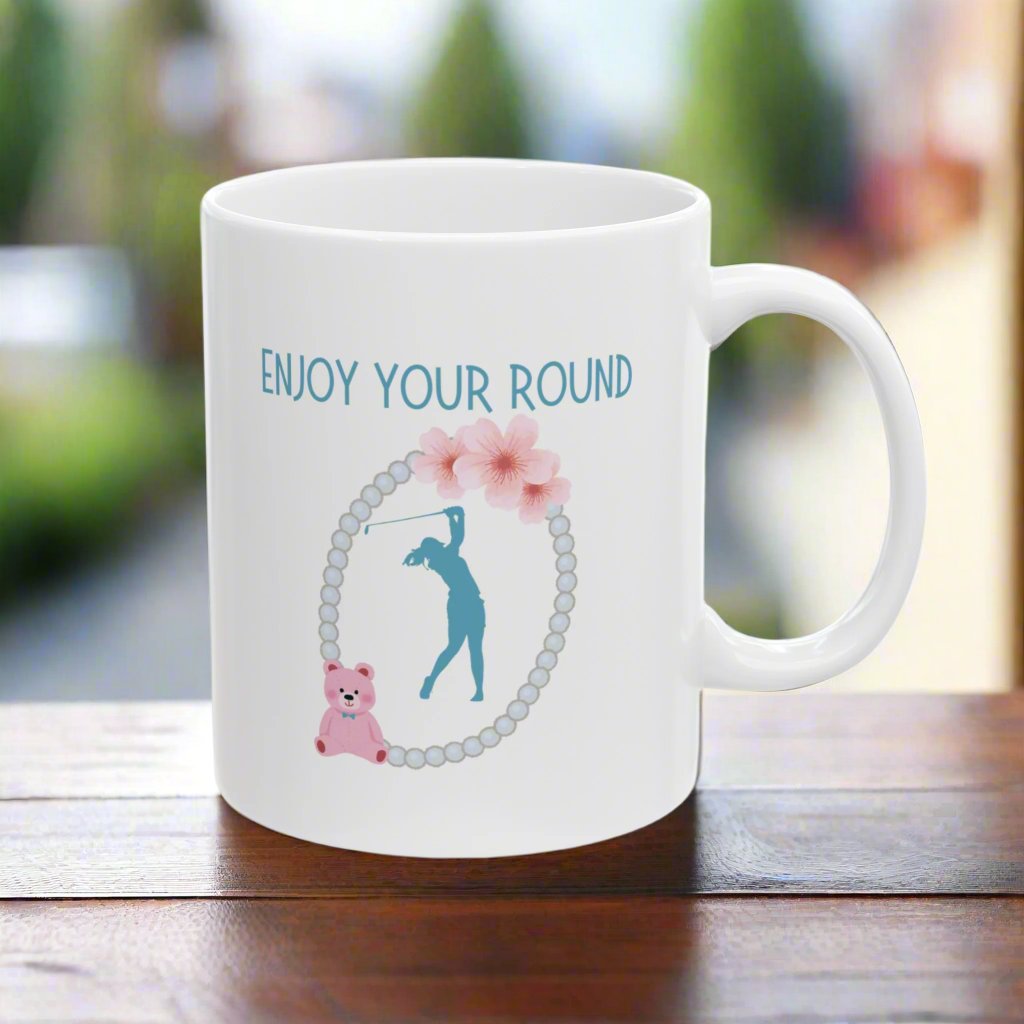 Enjoy Your Round Golf themed White Ceramic Mug, 11oz with the image of the golfer, teddybear, flowers and pearl necklace.