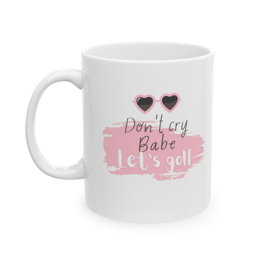Brighten your day and lift your spirits with the "Don't Cry Babe, Let's Golf" golf-themed ceramic mug. This 11oz white mug is designed for golf enthusiasts who appreciate a bit of humor and motivation with their morning brew. Perfect for enjoying coffee, tea, or any favorite beverage, this mug brings a touch of fun to your daily routine.