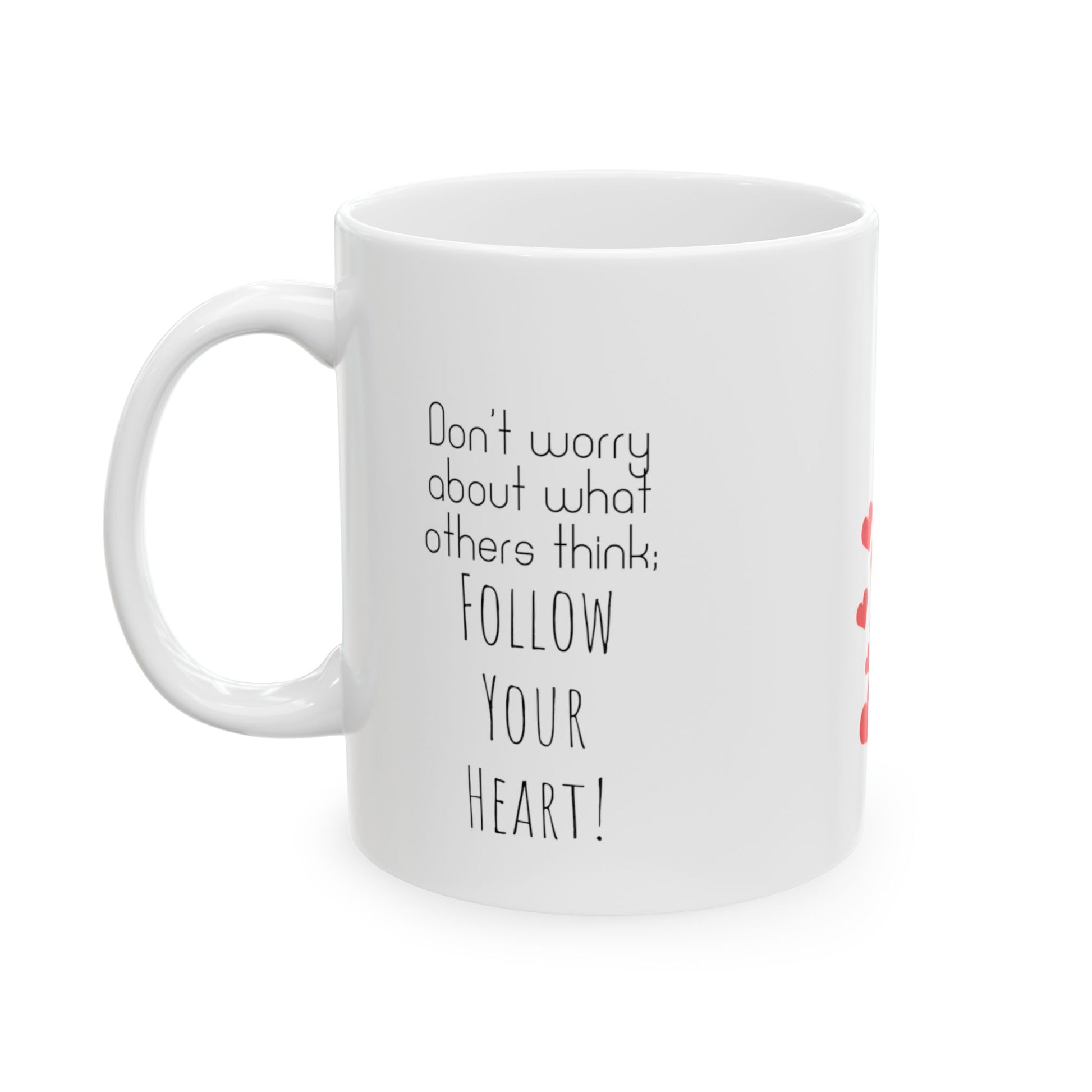 White ceramic mug with red hearts in the middle and the text on the both sides of the mug: Don't Worry About What Others Think, Follow Your Heart.