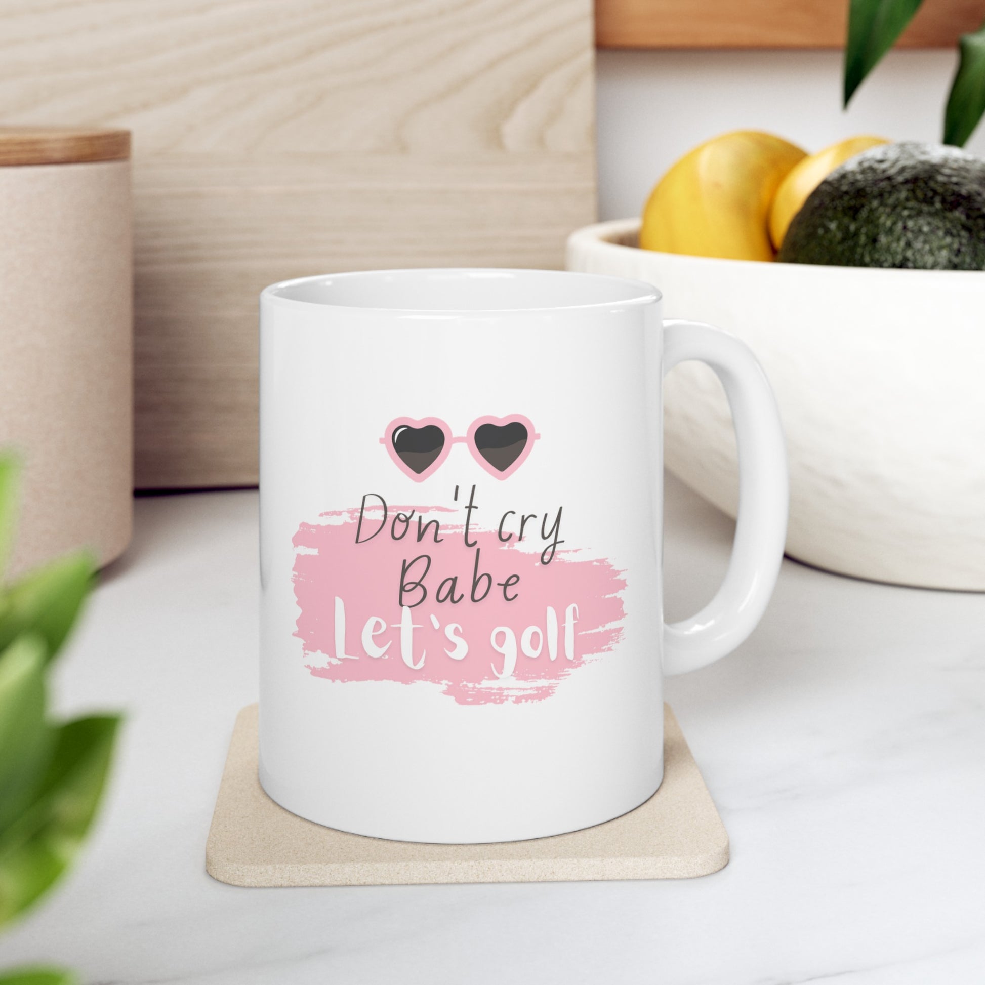 Brighten your day and lift your spirits with the "Don't Cry Babe, Let's Golf" golf-themed ceramic mug. This 11oz white mug is designed for golf enthusiasts who appreciate a bit of humor and motivation with their morning brew. Perfect for enjoying coffee, tea, or any favorite beverage, this mug brings a touch of fun to your daily routine.