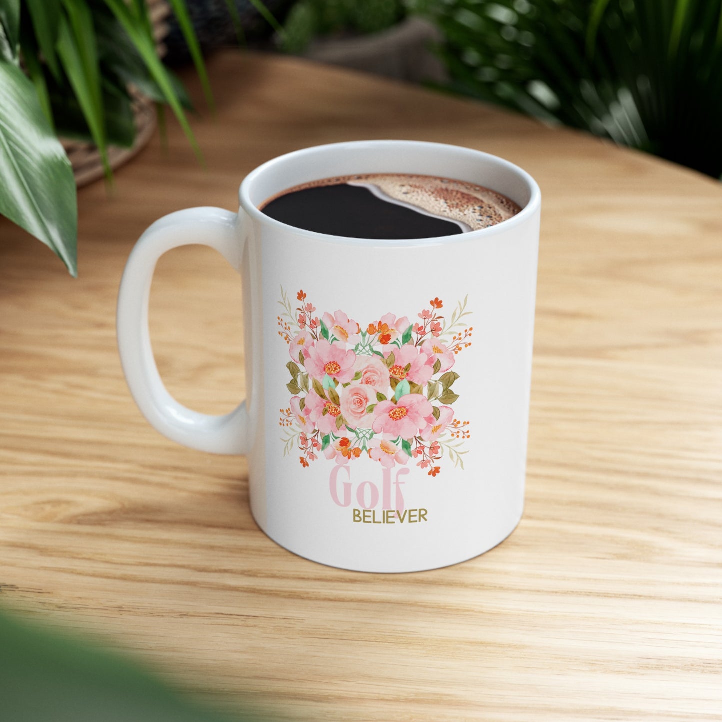 Favorite white ceramic coffee, tee or chocolate mug. The “Golf Believer” design features a blend of golf enthusiasm and blooming flowers, making it a unique choice for golf lovers. 