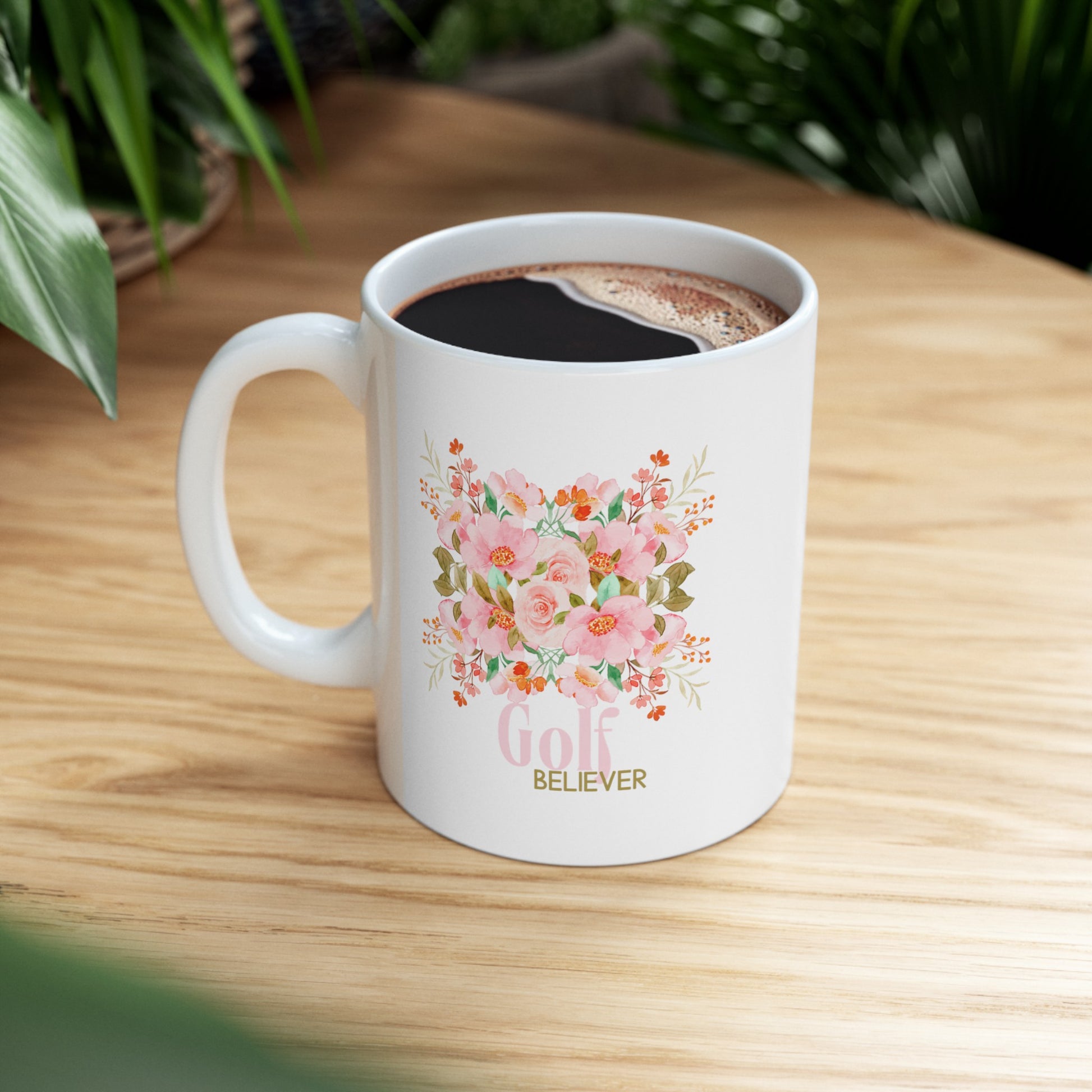 Favorite white ceramic coffee, tee or chocolate mug. The “Golf Believer” design features a blend of golf enthusiasm and blooming flowers, making it a unique choice for golf lovers. 