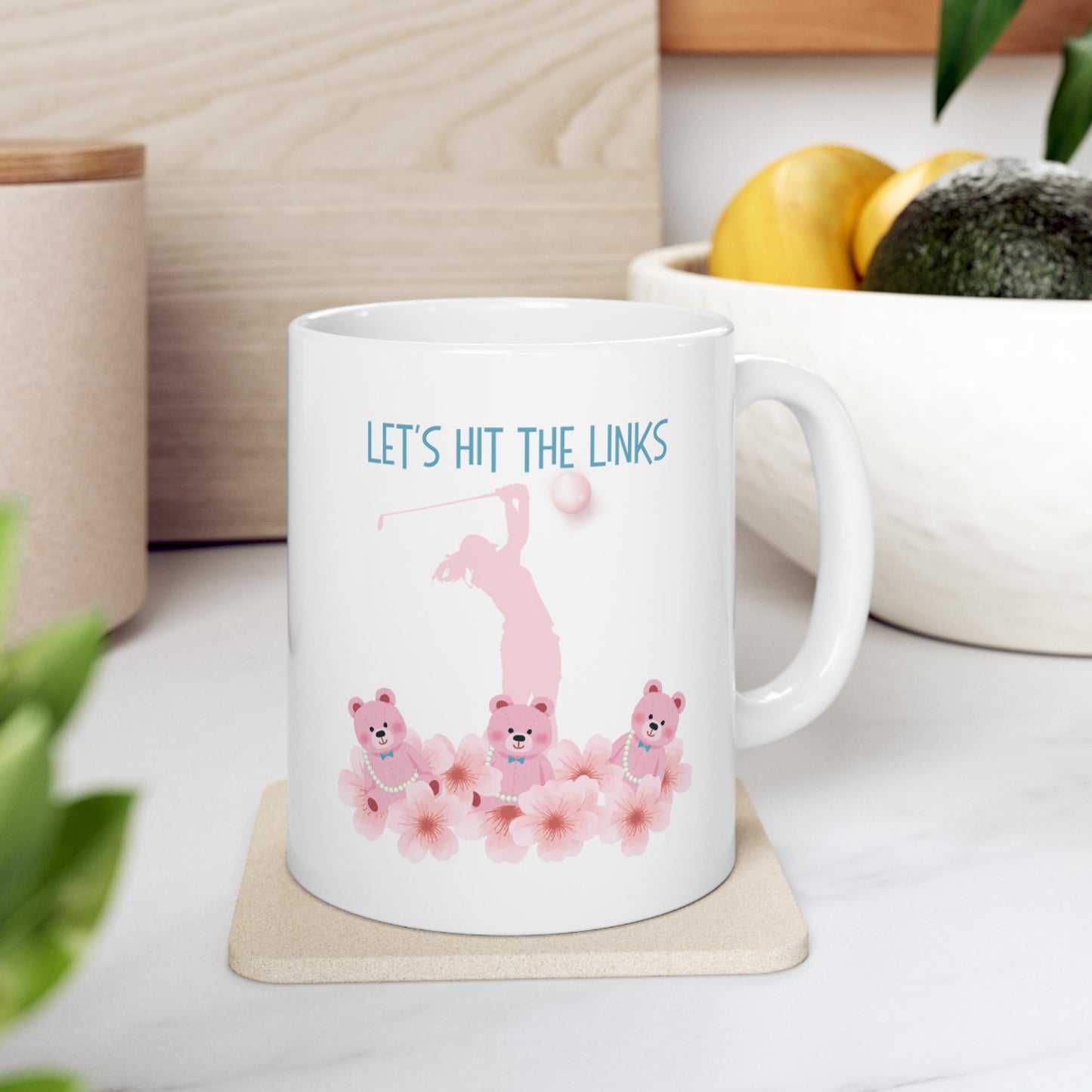 White golf themed mug. Tee off your day with this charming 11-ounce ceramic coffee mug. The playful design showcases adorable teddy bears surrounded by blooming flowers. 